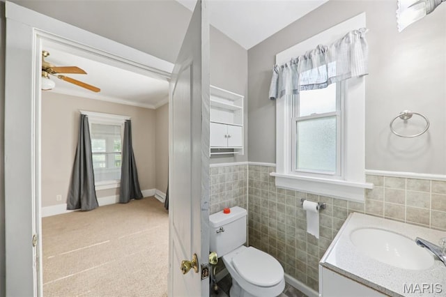 410 W Easton St, Gillespie, IL 62033 - bathroom featuring tile walls, ceiling fan, vanity, and wainscoting