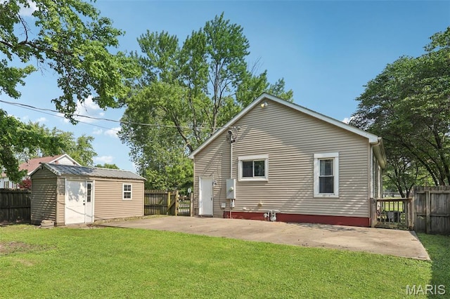 410 W Easton St, Gillespie, IL 62033 - back of property featuring a patio area, a fenced backyard, and an outbuilding