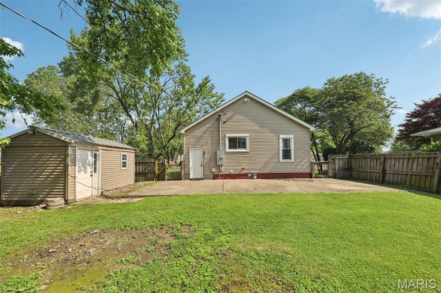 410 W Easton St, Gillespie, IL 62033 - back of property featuring a patio, a fenced backyard, and an outdoor structure