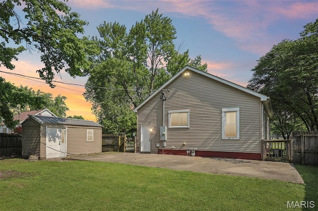 410 W Easton St, Gillespie, IL 62033 - back of house at dusk with a patio area and a storage shed
