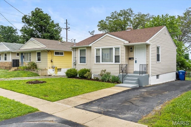 209 Monica Dr, Saint Louis, MO 63127 - view of front facade featuring a chimney, a front yard, and roof with shingles