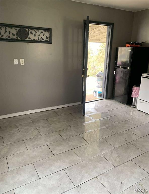 408 4th St, Doniphan, MO 63935 - spare room with light tile patterned floors and baseboards