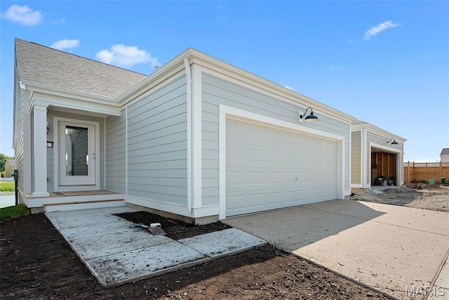 114 Marais Temps Clair, Saint Charles, MO 63301 - view of front of house featuring an attached garage, driveway, and a shingled roof