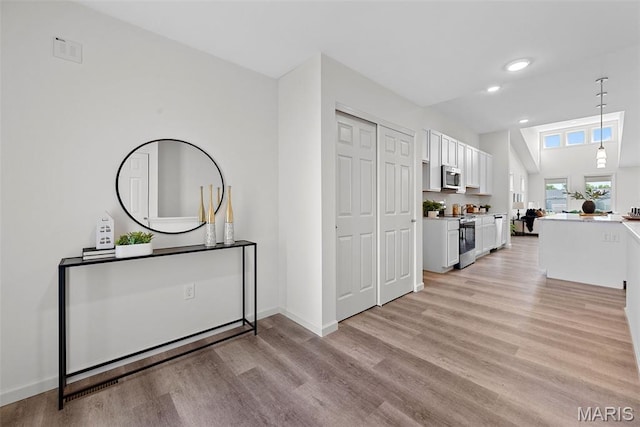114 Marais Temps Clair, Saint Charles, MO 63301 - kitchen featuring stainless steel appliances, white cabinets, light wood finished floors, hanging light fixtures, and recessed lighting