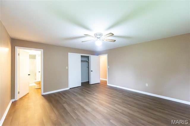 21 Mcfarland Dr, Rolla, MO 65401 - unfurnished bedroom featuring wood finished floors, a closet, ceiling fan, and ensuite bath