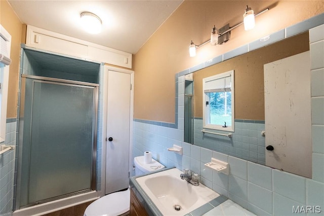 21 Mcfarland Dr, Rolla, MO 65401 - bathroom featuring tile walls, vanity, a stall shower, and a wainscoted wall