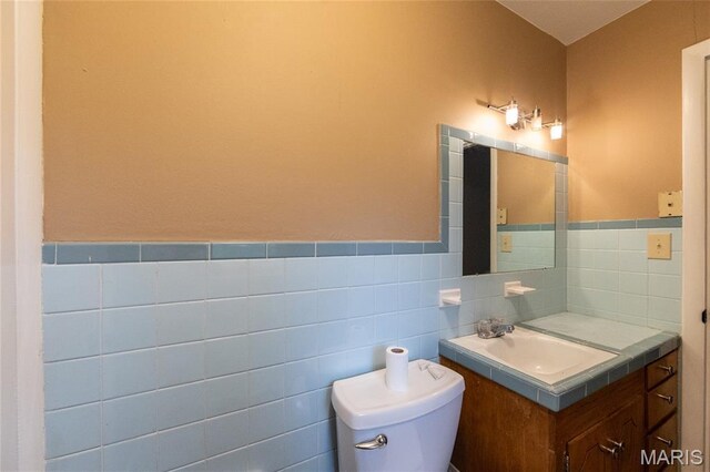 21 Mcfarland Dr, Rolla, MO 65401 - bathroom with vanity, tile walls, and a wainscoted wall