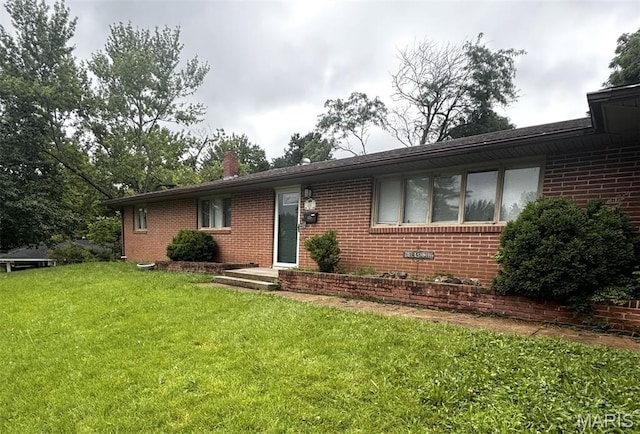 21 Mcfarland Dr, Rolla, MO 65401 - ranch-style house featuring brick siding, a front lawn, and a chimney
