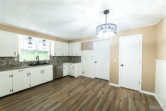 21 Mcfarland Dr, Rolla, MO 65401 - kitchen featuring stainless steel dishwasher, dark countertops, decorative backsplash, dark wood-type flooring, and white cabinetry