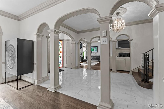 1259 Hampton Park Dr, Richmond Heights, MO 63117 - entrance foyer with ornate columns, arched walkways, ornamental molding, and marble finish floors
