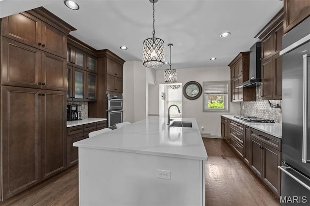 1259 Hampton Park Dr, Richmond Heights, MO 63117 - kitchen with wall chimney range hood, a chandelier, dark wood-style flooring, stainless steel appliances, and recessed lighting