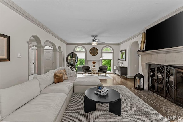 1259 Hampton Park Dr, Richmond Heights, MO 63117 - living area featuring decorative columns, ceiling fan, a fireplace, ornamental molding, and arched walkways