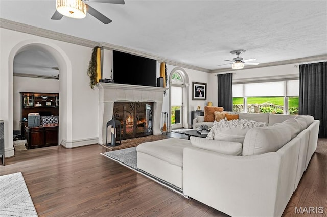 1259 Hampton Park Dr, Richmond Heights, MO 63117 - living area featuring ceiling fan, crown molding, a tile fireplace, wood finished floors, and arched walkways