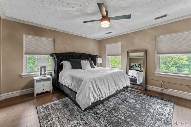 1259 Hampton Park Dr, Richmond Heights, MO 63117 - bedroom with multiple windows, wood finished floors, ornamental molding, a textured ceiling, and ceiling fan