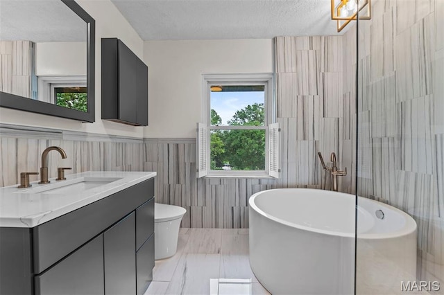 1259 Hampton Park Dr, Richmond Heights, MO 63117 - full bath with a freestanding tub, vanity, healthy amount of natural light, a textured ceiling, and tile walls