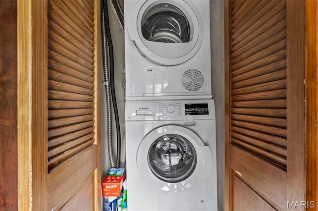 1259 Hampton Park Dr, Richmond Heights, MO 63117 - washroom featuring stacked washer and clothes dryer and log walls
