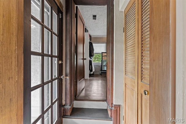 1259 Hampton Park Dr, Richmond Heights, MO 63117 - corridor with french doors, a textured ceiling, and wood finished floors
