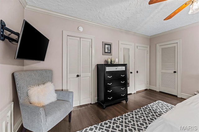 1259 Hampton Park Dr, Richmond Heights, MO 63117 - bedroom featuring dark wood-type flooring, two closets, a textured ceiling, ornamental molding, and a ceiling fan