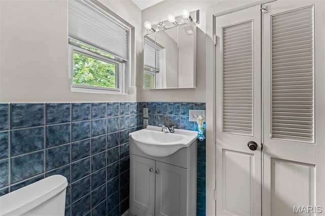 1259 Hampton Park Dr, Richmond Heights, MO 63117 - bathroom featuring vanity, tile walls, and a wainscoted wall