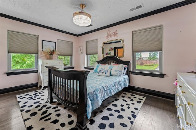 1259 Hampton Park Dr, Richmond Heights, MO 63117 - bedroom featuring wood finished floors, multiple windows, crown molding, and a textured ceiling