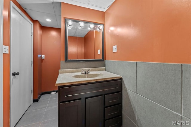 1259 Hampton Park Dr, Richmond Heights, MO 63117 - bathroom featuring vanity, tile patterned floors, a paneled ceiling, and wainscoting