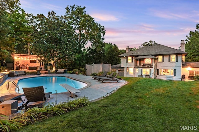 1259 Hampton Park Dr, Richmond Heights, MO 63117 - pool at dusk with a patio area, a diving board, and an outdoor pool