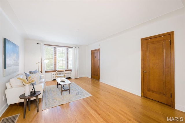 8100 Delmar Blvd Unit 1W, University City, MO 63130 - living area featuring radiator and light wood-type flooring