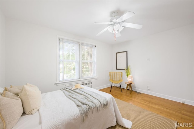 8100 Delmar Blvd Unit 1W, University City, MO 63130 - bedroom featuring wood finished floors, radiator, and ceiling fan