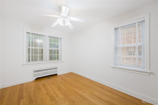 8100 Delmar Blvd Unit 1W, University City, MO 63130 - unfurnished room featuring radiator, light wood-type flooring, and a ceiling fan