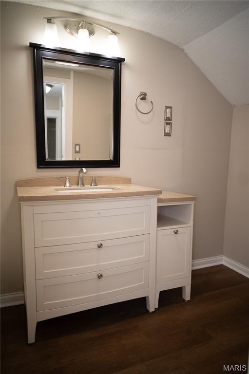 503 N Meramec St, St James, MO 65559 - bathroom featuring lofted ceiling, wood finished floors, and vanity