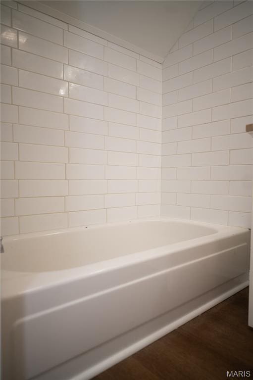 503 N Meramec St, St James, MO 65559 - full bathroom with wood finished floors, vaulted ceiling, and bathtub / shower combination