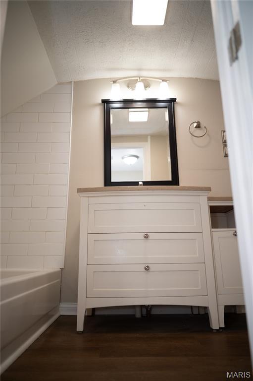 503 N Meramec St, St James, MO 65559 - full bath with wood finished floors, vanity, and  shower combination