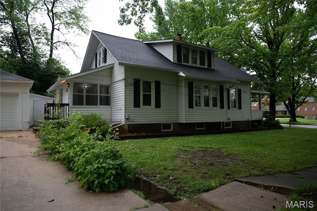 503 N Meramec St, St James, MO 65559 - view of side of property with an outbuilding, a garage, roof with shingles, a lawn, and a chimney