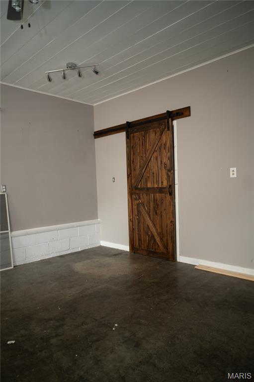 503 N Meramec St, St James, MO 65559 - spare room with a barn door and concrete flooring