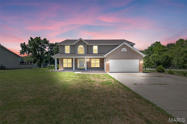 11264 Village Dr, Foristell, MO 63348 - traditional-style home featuring concrete driveway, a garage, covered porch, and a lawn
