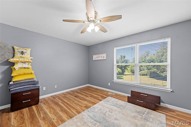 11264 Village Dr, Foristell, MO 63348 - bedroom with wood finished floors and a ceiling fan