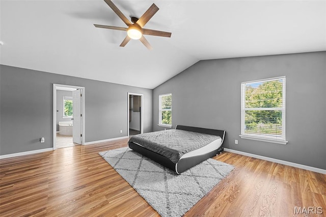 11264 Village Dr, Foristell, MO 63348 - bedroom featuring vaulted ceiling, wood finished floors, ensuite bath, a walk in closet, and a ceiling fan