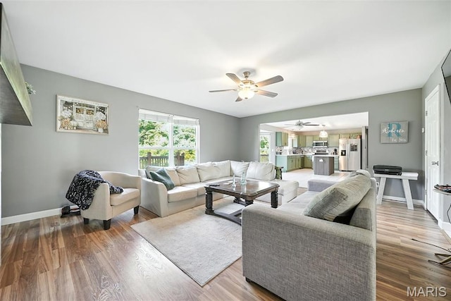 11264 Village Dr, Foristell, MO 63348 - living area featuring ceiling fan and wood finished floors