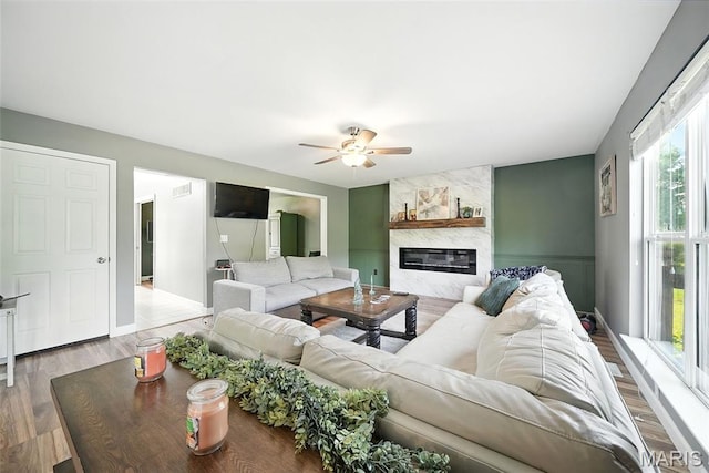 11264 Village Dr, Foristell, MO 63348 - living room featuring a ceiling fan, a premium fireplace, and wood finished floors