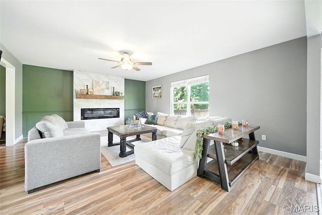 11264 Village Dr, Foristell, MO 63348 - living room featuring ceiling fan, a premium fireplace, and light wood-style flooring