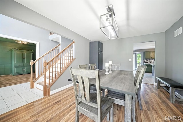 11264 Village Dr, Foristell, MO 63348 - dining space with light wood-style flooring and stairs