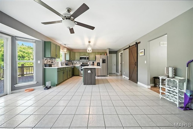 11264 Village Dr, Foristell, MO 63348 - kitchen featuring green cabinets, appliances with stainless steel finishes, a barn door, light countertops, and ceiling fan