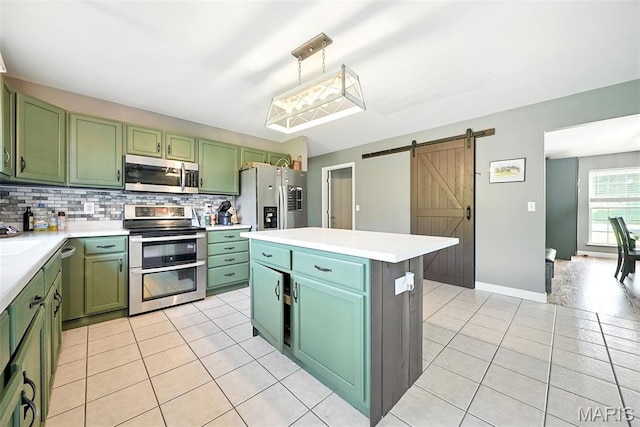 11264 Village Dr, Foristell, MO 63348 - kitchen featuring green cabinets, appliances with stainless steel finishes, a barn door, and light tile patterned floors