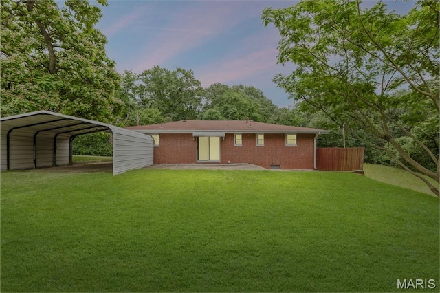 3120 Hawthorne Blvd, Alton, IL 62002 - back of house at dusk with a detached carport and brick siding