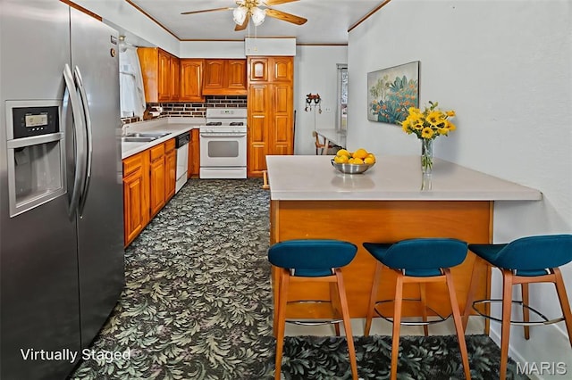 3120 Hawthorne Blvd, Alton, IL 62002 - kitchen featuring stainless steel fridge, white gas range, a peninsula, brown cabinetry, and dishwashing machine