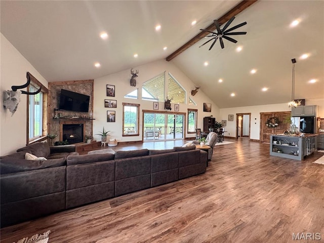 14005 Osage Dr, New London, MO 63459 - living area with beam ceiling, high vaulted ceiling, a stone fireplace, wood finished floors, and a ceiling fan