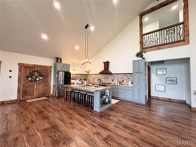 14005 Osage Dr, New London, MO 63459 - kitchen with stainless steel fridge, gray cabinetry, open shelves, high vaulted ceiling, and premium range hood