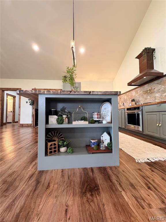 14005 Osage Dr, New London, MO 63459 - kitchen view of oven, wall chimney exhaust hood, gray cabinets, dark wood finished floors, and tasteful backsplash