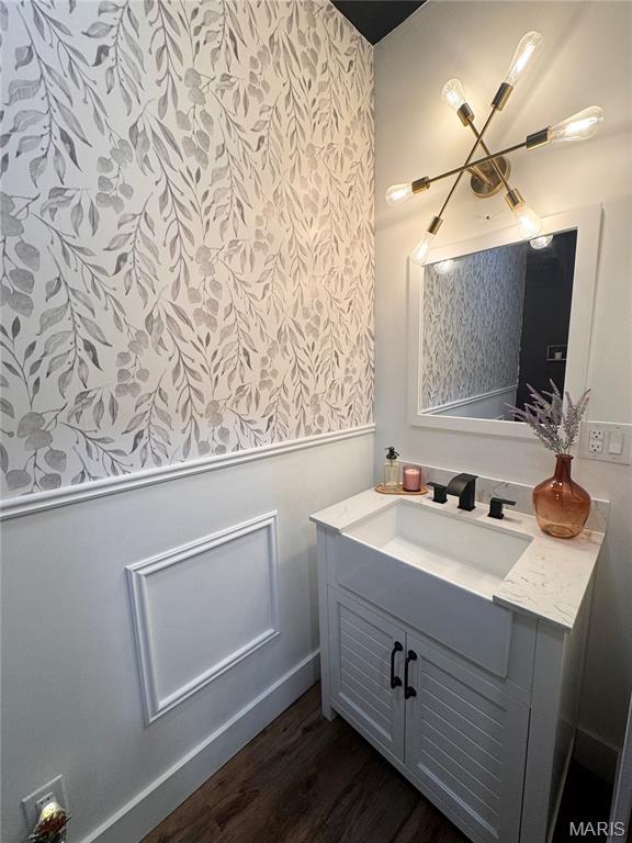 14005 Osage Dr, New London, MO 63459 - bathroom featuring wallpapered walls, vanity, and wood finished floors
