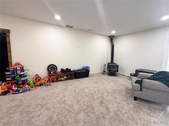 14005 Osage Dr, New London, MO 63459 - playroom with carpet flooring, a wood stove, and recessed lighting
